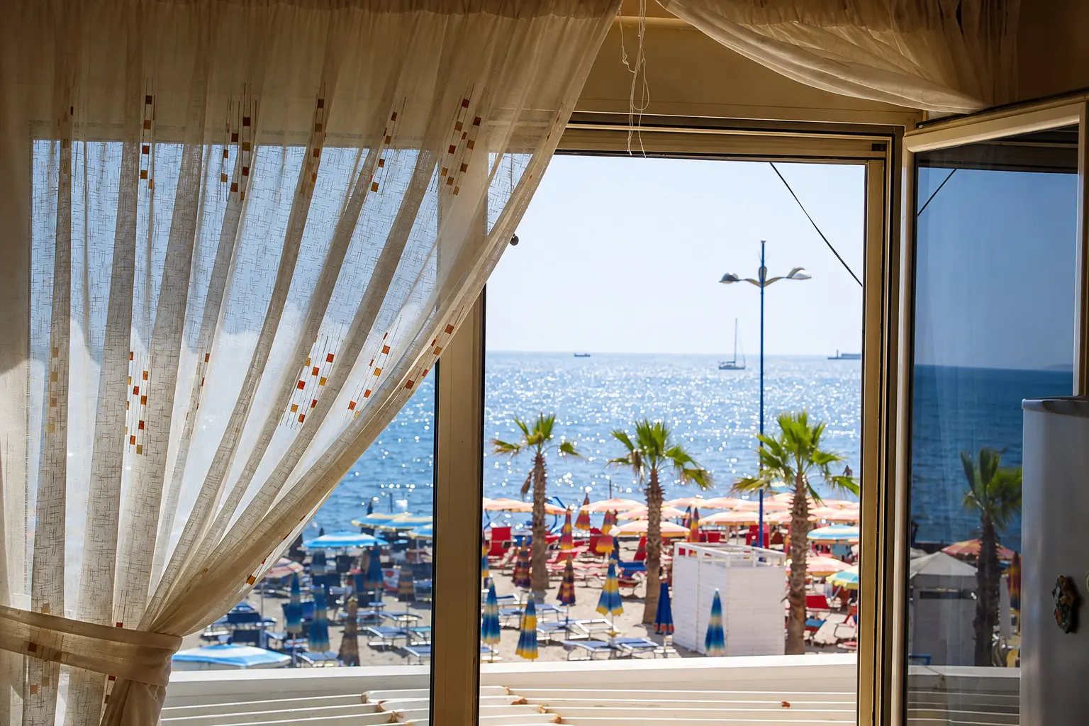 Morning light through the apartment window with the Adriatic beyond